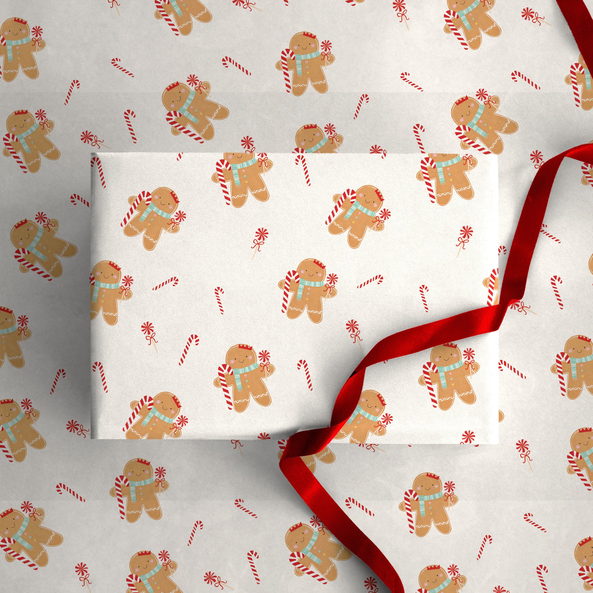 Gingerbread Christmas wrapping paper featuring a pattern of gingerbread men with blue scarves and candy canes.