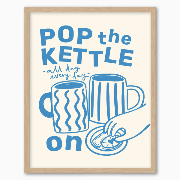 Pop the Kettle Blue framed print featuring blue illustrations of mugs and a hand with a biscuit in a light wood frame.