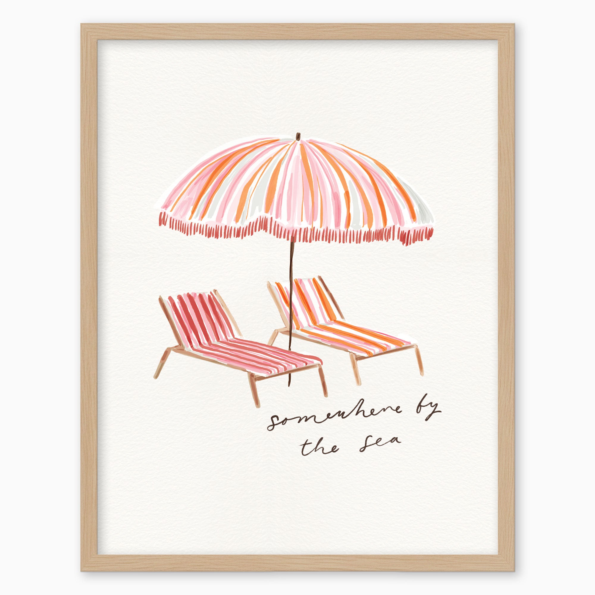 Somewhere by the Sea pink framed print featuring a striped beach umbrella and two sun loungers in a light wood frame.