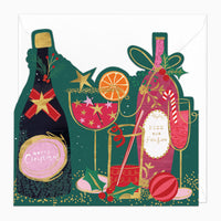 Cut Out Cheers Green Christmas card featuring bottles, cocktails, and festive decorations on a dark green background.