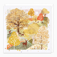Autumn Woodland Art Card featuring a deer in a golden forest with orange and yellow trees, set against a white envelope.