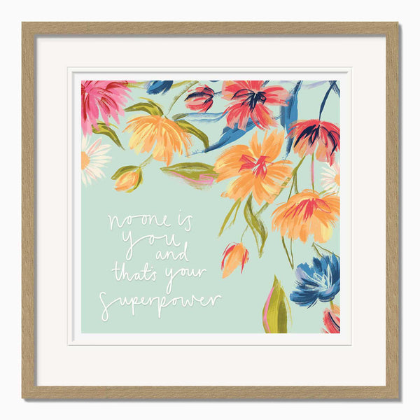 Floral Strength framed print featuring colourful painted flowers on a pale blue background with the text No one is you.