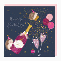Hedgehogs Pop Champagne birthday card with a navy background, pink balloons, champagne bottle, and party-hatted hedgehogs.