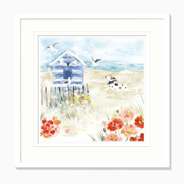 Patch by the Beach Hut framed print featuring a spotted dog running on a sandy beach with a blue hut and red poppies.