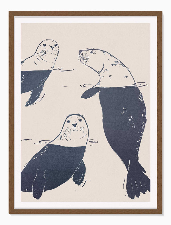 Sea Lions large framed print featuring three navy blue illustrations of seals swimming on a light cream background.