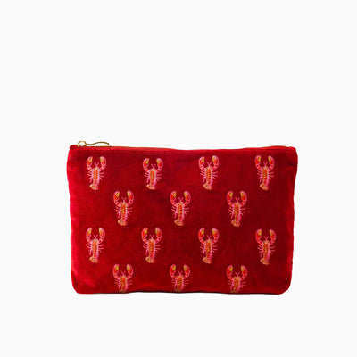 Red velvet everyday pouch featuring an embroidered repeating lobster pattern and a gold-toned zip fastening.