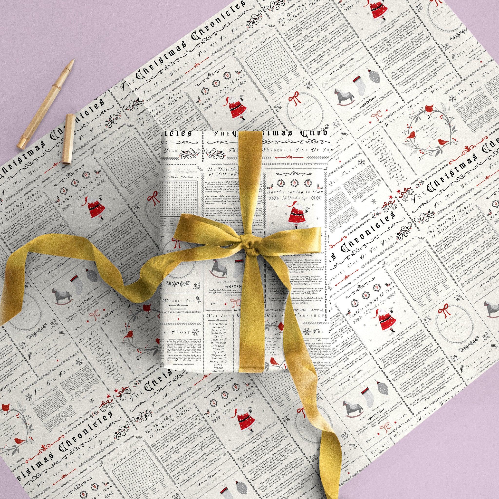Chronicles Christmas wrapping paper featuring a newspaper-style print with red and black festive illustrations and a gold ribbon.