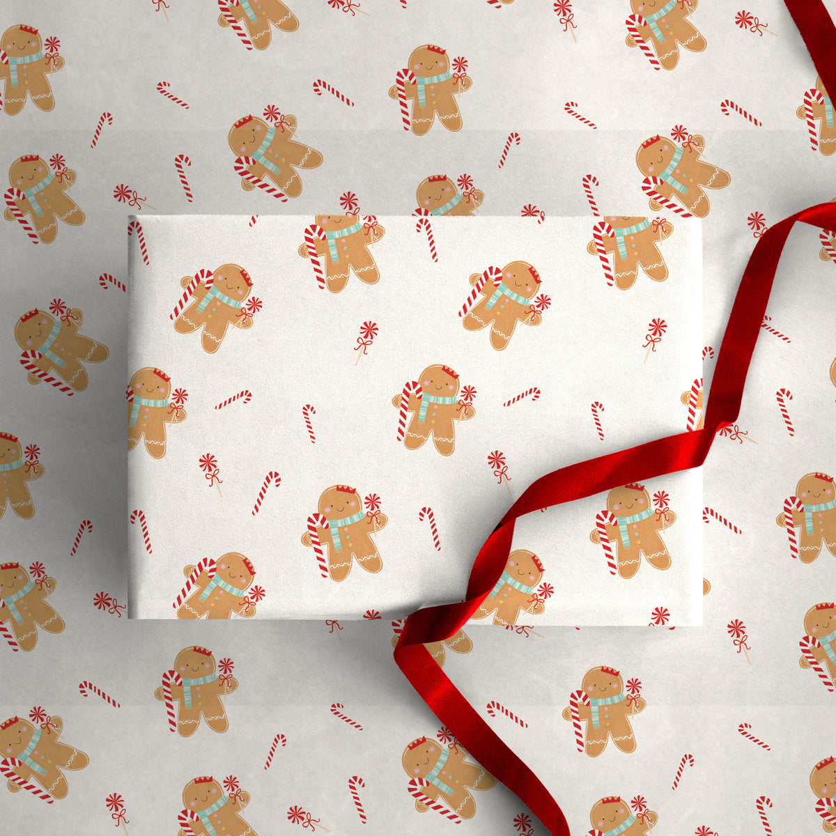 Gingerbread Christmas wrapping paper featuring a pattern of gingerbread men with blue scarves and candy canes.