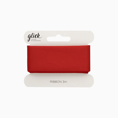 A 3m roll of smooth red satin ribbon wrapped around a white cardboard display card.
