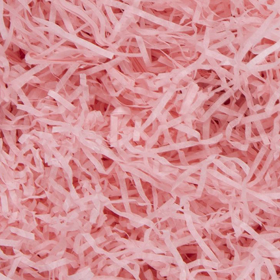 Light pink shredded tissue paper for gift packaging and hamper filling.