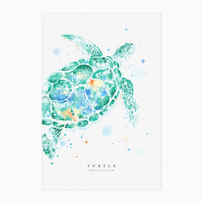 Turtle Tea Towel featuring a vibrant watercolour illustration of a green sea turtle with blue and orange paint splashes.