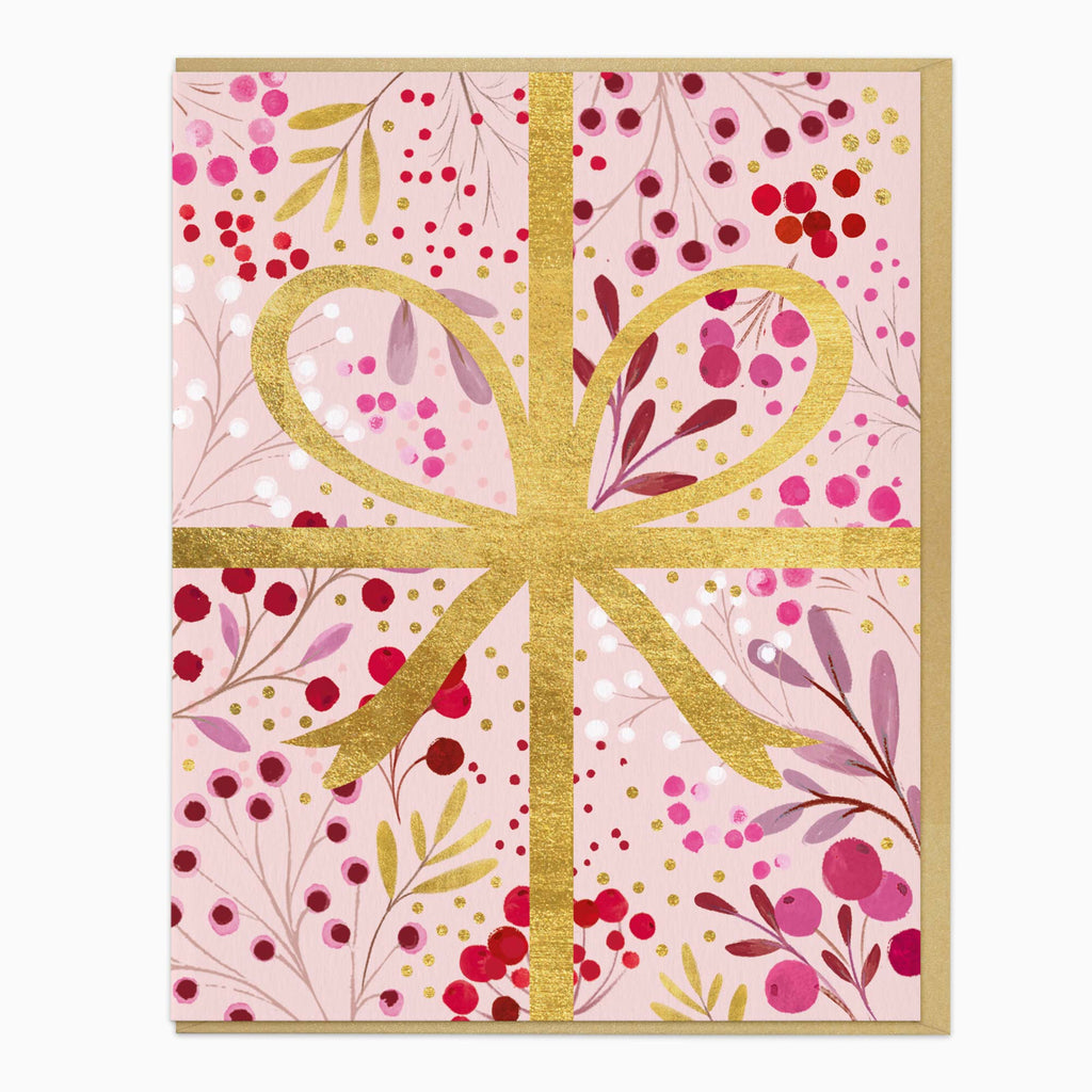 Bursting Berry Ribbon Christmas card featuring a gold ribbon design over a pink background with red berries and foliage.