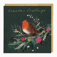 Robin and Winter Foliage Christmas card featuring a robin on a dark green background with gold stars and a gold envelope.