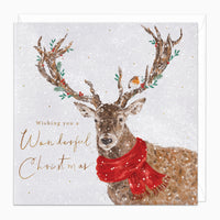 Robin In The Antlers Christmas card featuring a deer in a red scarf with a robin, holly, and gold festive text.