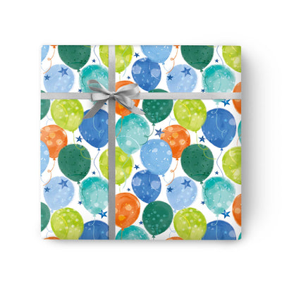 Balloons And Stars wrapping paper featuring a colourful pattern of balloons and stars, tied with a silver ribbon.