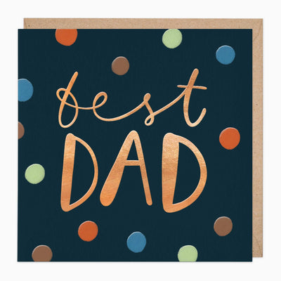 Best Dad greeting card with copper lettering on a dark blue background featuring colourful polka dots and a brown envelope.