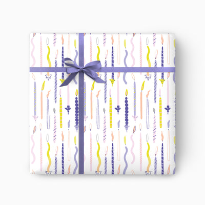 Bright Candles wrapping paper featuring a colourful pattern of candles tied with a purple ribbon and bow.