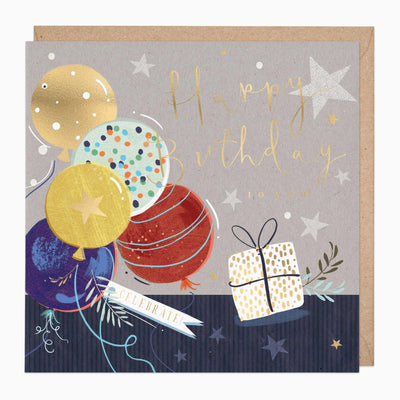 Celebration Extravaganza Birthday card with colourful balloons, a gift box and stars on a grey background with an envelope.