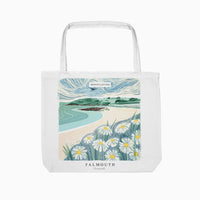 White tote bag featuring a lino-style illustration of a Falmouth beach with daisies in the foreground and blue sea.