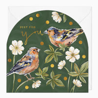 Finch & Anemone Just For You arch-shaped greeting card with two birds, white flowers, and gold dots on a dark green background.