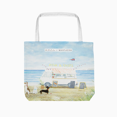 First In Line tote bag featuring a seaside fish and chips van illustration with three dogs on a sandy beach.