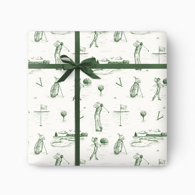 Golf Toile wrapping paper featuring green ink sketches of golfers, clubs, and courses, tied with a dark green ribbon.