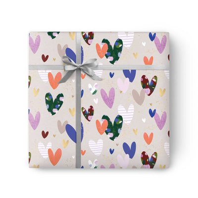 Grey Heart Wrapping Paper featuring a colourful pattern of painted hearts tied with a silver ribbon.