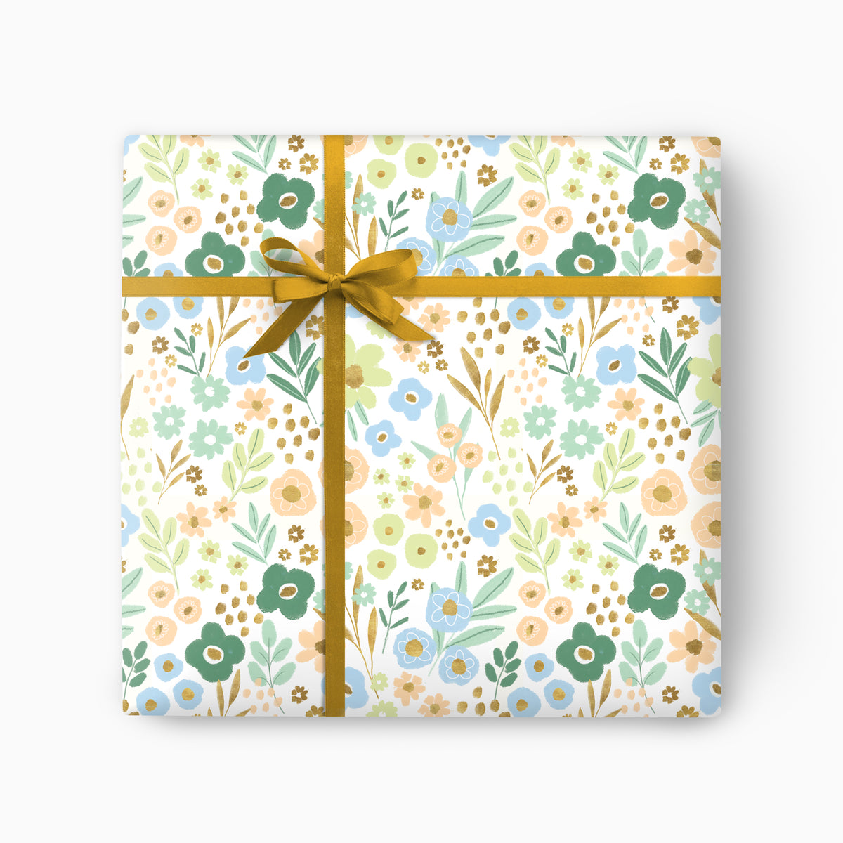 Meadow Bloom wrapping paper featuring a floral pattern in soft blue, green, and peach, tied with a gold ribbon.