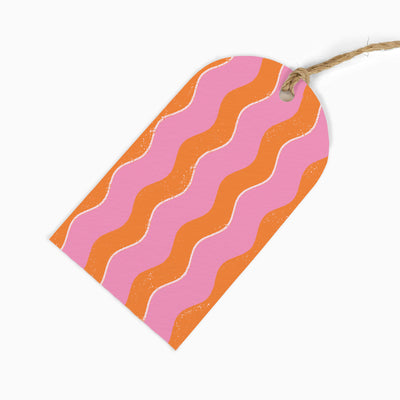 Pink Wibbly Stripes gift tag with orange and pink wavy lines, attached to a piece of natural twine.