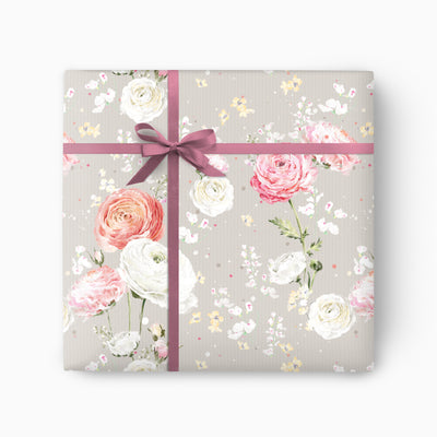 Ranunculus Blooms wrapping paper featuring pink and white floral illustrations on a grey striped background with a pink ribbon.