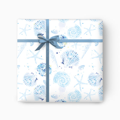 Sea Shells wrapping paper featuring blue watercolour shells and starfish on a white background with a blue ribbon bow.