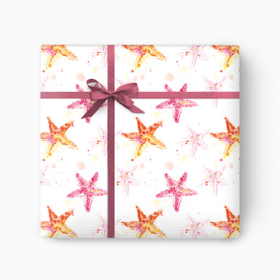 Starfish Wrapping Paper featuring a watercolour pattern of pink and orange starfish on a white background with a dark ribbon.