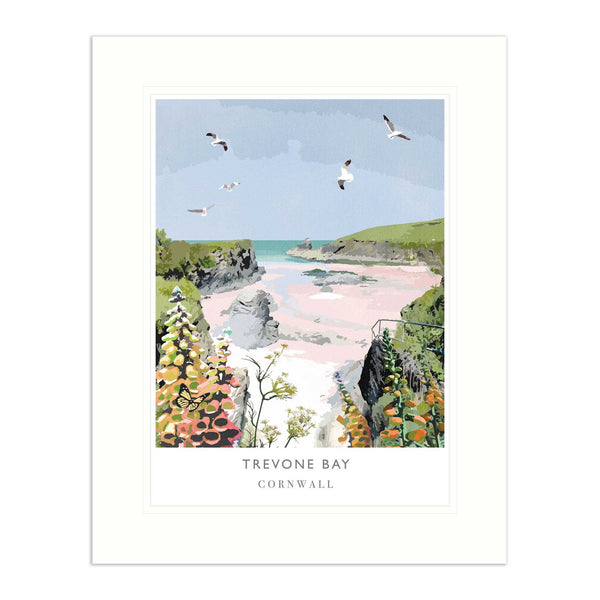 Trevone Bay mounted print featuring a coastal landscape with pink sands, rocky cliffs, wildflowers, and flying seagulls.