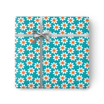Turquoise wrapping paper featuring a white and orange daisy pattern, tied with a grey ribbon and bow.